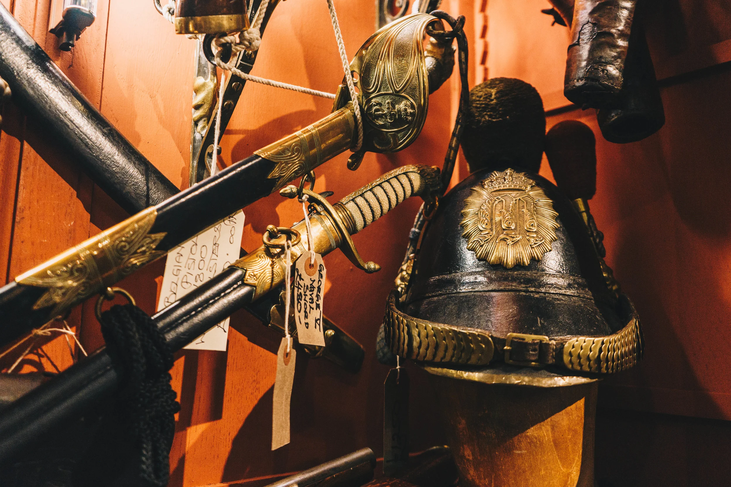 Antique military swords, helmet and brass collectibles in a Tokyo shop