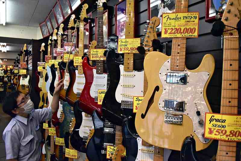 Wall of used electric guitars in a Tokyo music shop